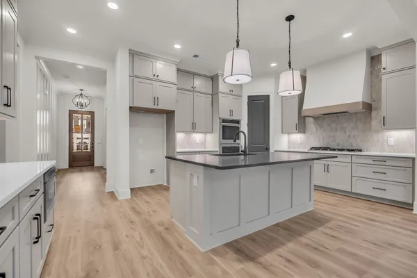 a kitchen with stainless steel appliances granite countertop a sink a microwave and cabinets