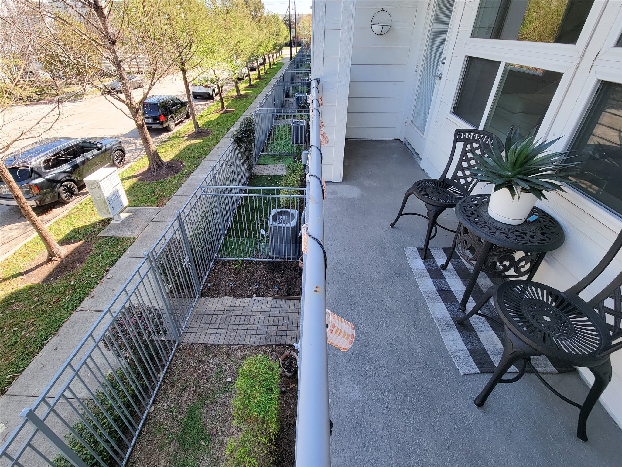 1705 Eado Point Lane Houston, TX 77003 - Photo 35 of 50 The balcony overlooks a tree-lined sidewalk and street, providing a pleasant outdoor space for relaxation and plenty of guest parking.