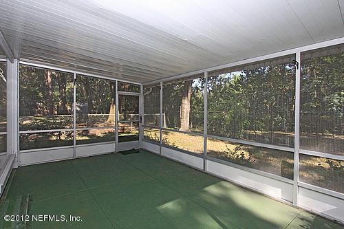 3045 Kline Road Jacksonville, FL 32246 - Photo 12 of 15 a view of an empty room with a floor to ceiling window and an outdoor view