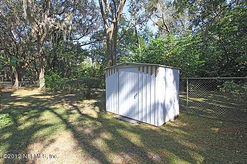 3045 Kline Road Jacksonville, FL 32246 - Photo 15 of 15 a backyard of a house with large trees and wooden fence