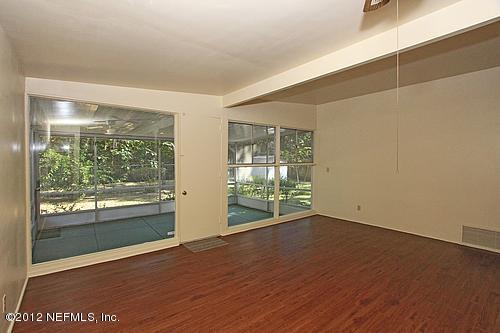 3045 Kline Road Jacksonville, FL 32246 - Photo 6 of 15 an empty room with wooden floor and windows