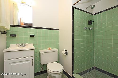 3045 Kline Road Jacksonville, FL 32246 - Photo 8 of 15 a bathroom with a toilet a sink and a mirror
