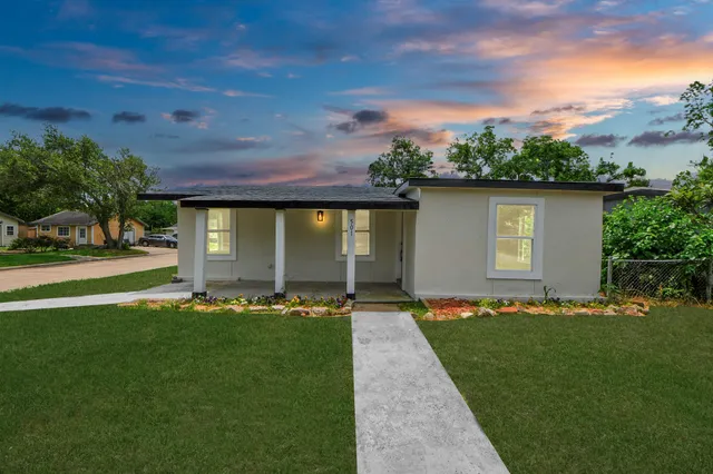a front view of a house with a garden