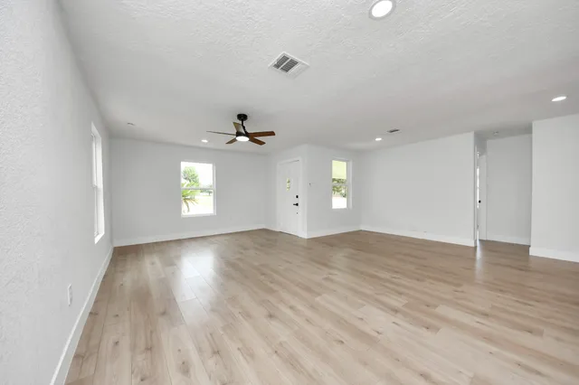 wooden floor in an empty room with a window