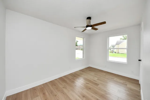 wooden floor in an empty room with a window