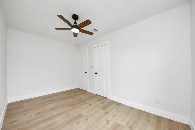a view of a ceiling fan with wooden floor