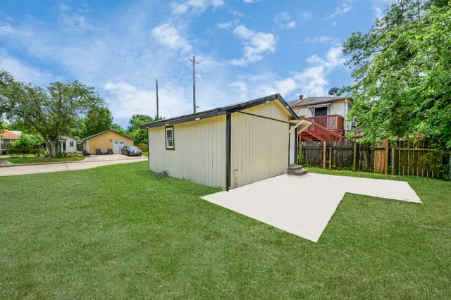 a view of a backyard with a garden and entertaining space