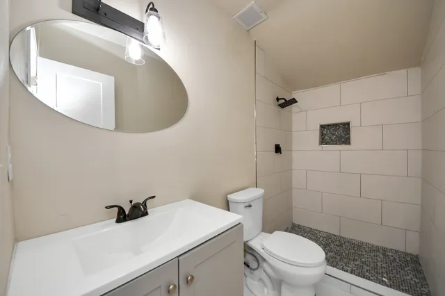 a bathroom with a sink toilet and shower