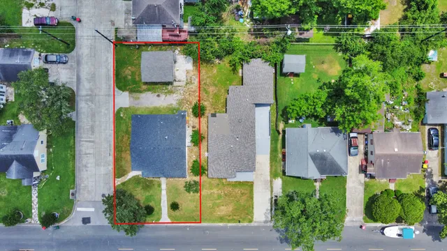 an aerial view of a house with a yard and garden