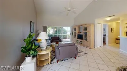 a living room with furniture a chandelier and a potted plant