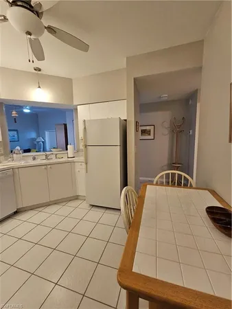a kitchen with a sink appliances and cabinets