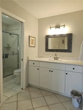 a bathroom with a double vanity sink mirror and toilet