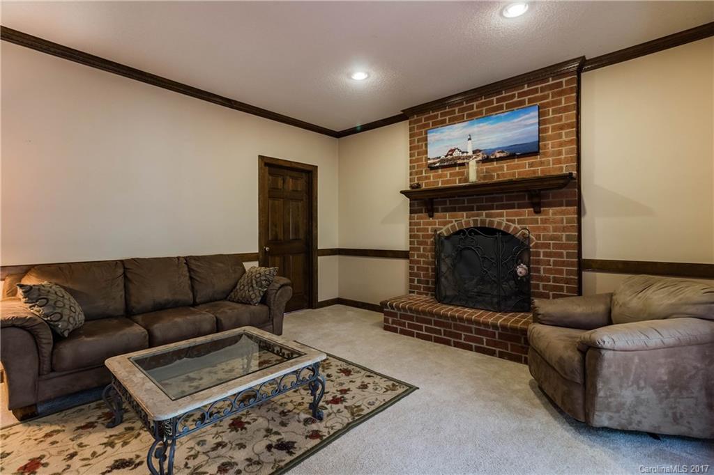 1697 Double Oaks Road Fort Mill, SC 29715 - Photo 12 of 24 a living room with furniture and a fireplace