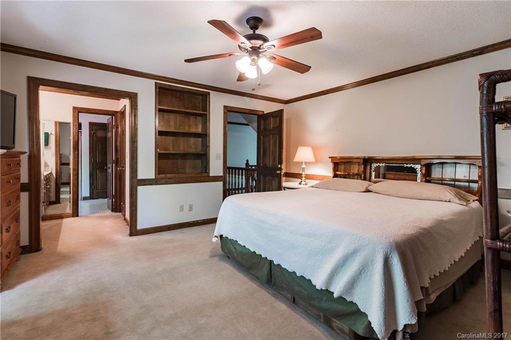 1697 Double Oaks Road Fort Mill, SC 29715 - Photo 14 of 24 a bedroom with a bed and a large cabinets