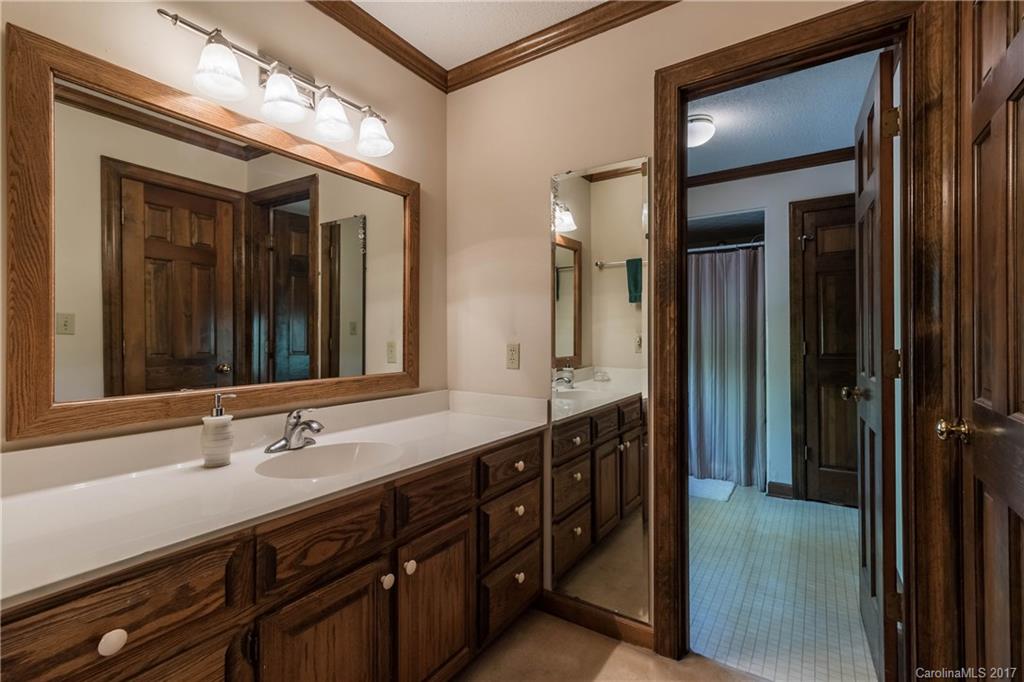 1697 Double Oaks Road Fort Mill, SC 29715 - Photo 15 of 24 a bathroom with a double vanity sink and a mirror