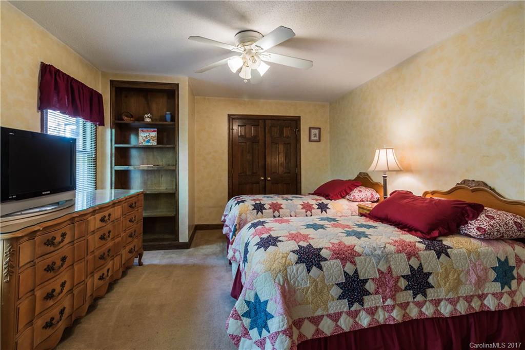 1697 Double Oaks Road Fort Mill, SC 29715 - Photo 17 of 24 a bedroom with a bed and a flat screen tv