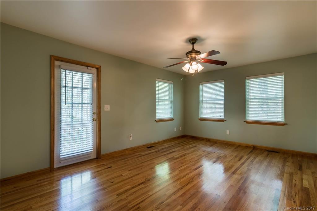 1697 Double Oaks Road Fort Mill, SC 29715 - Photo 21 of 24 a view of an empty room with wooden floor and a window