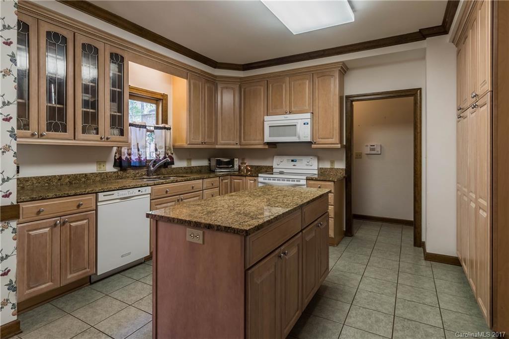 1697 Double Oaks Road Fort Mill, SC 29715 - Photo 7 of 24 a kitchen with stainless steel appliances granite countertop a sink stove and cabinets