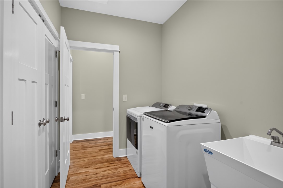 405 Pawnee Drive Walhalla, SC 29691 - Photo 21 of 36 Functional utility room featuring a large wash basin, hardwood flooring, and included washer and dryer.