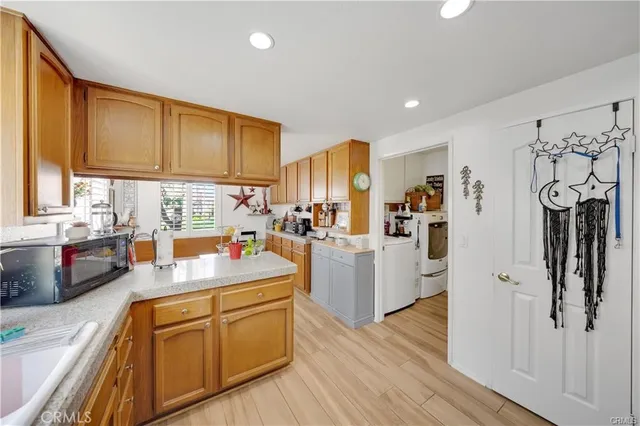 a kitchen with refrigerator cabinets and wooden floor