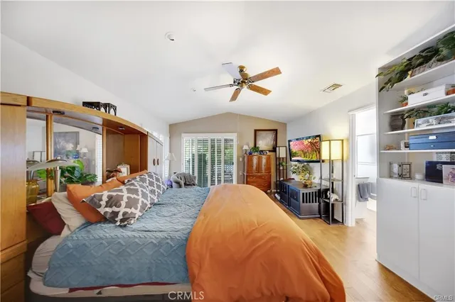 a bed room with a bed mirror and a dresser