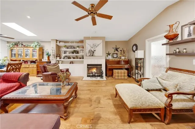 a living room with fireplace furniture and a wooden floor