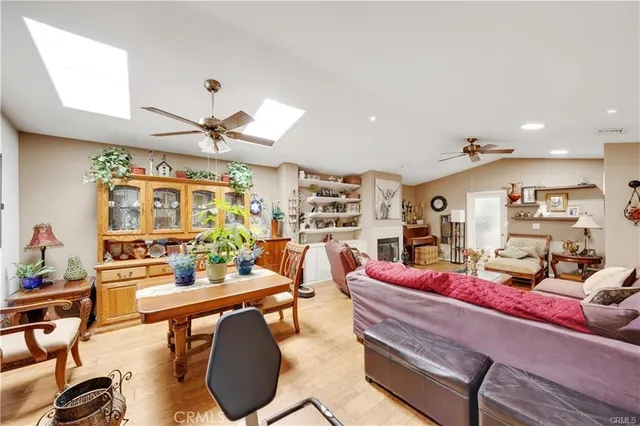 a living room with furniture kitchen view and a large window