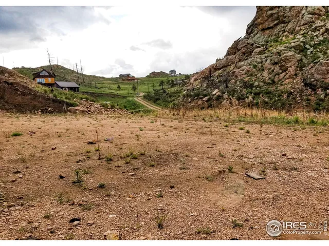 a view of a yard with wooden fence