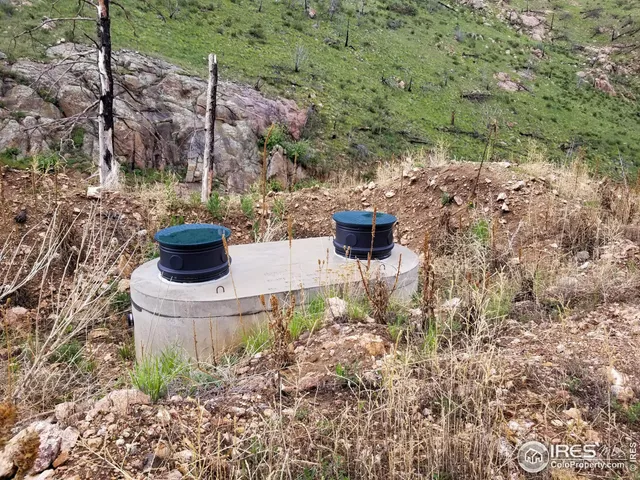 a view of a large building with mountains in the background