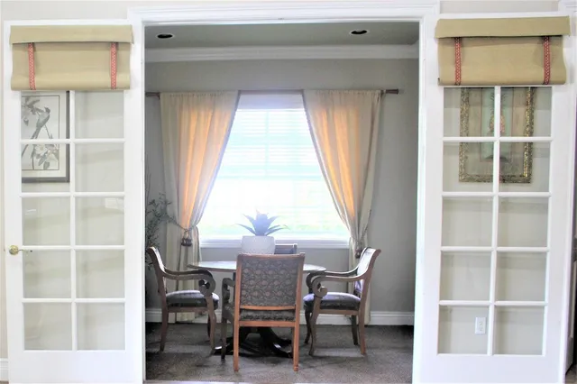 a view of a workspace with furniture and a window