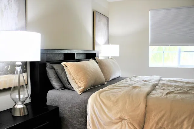 a bedroom with two beds and painting on the wall