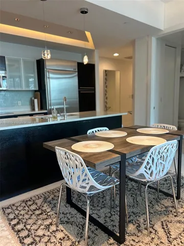 a dining area with granite countertop a sink table and chairs