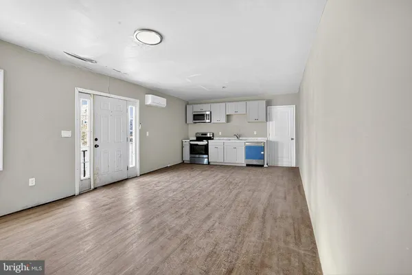 a view of a kitchen with a sink and cabinets