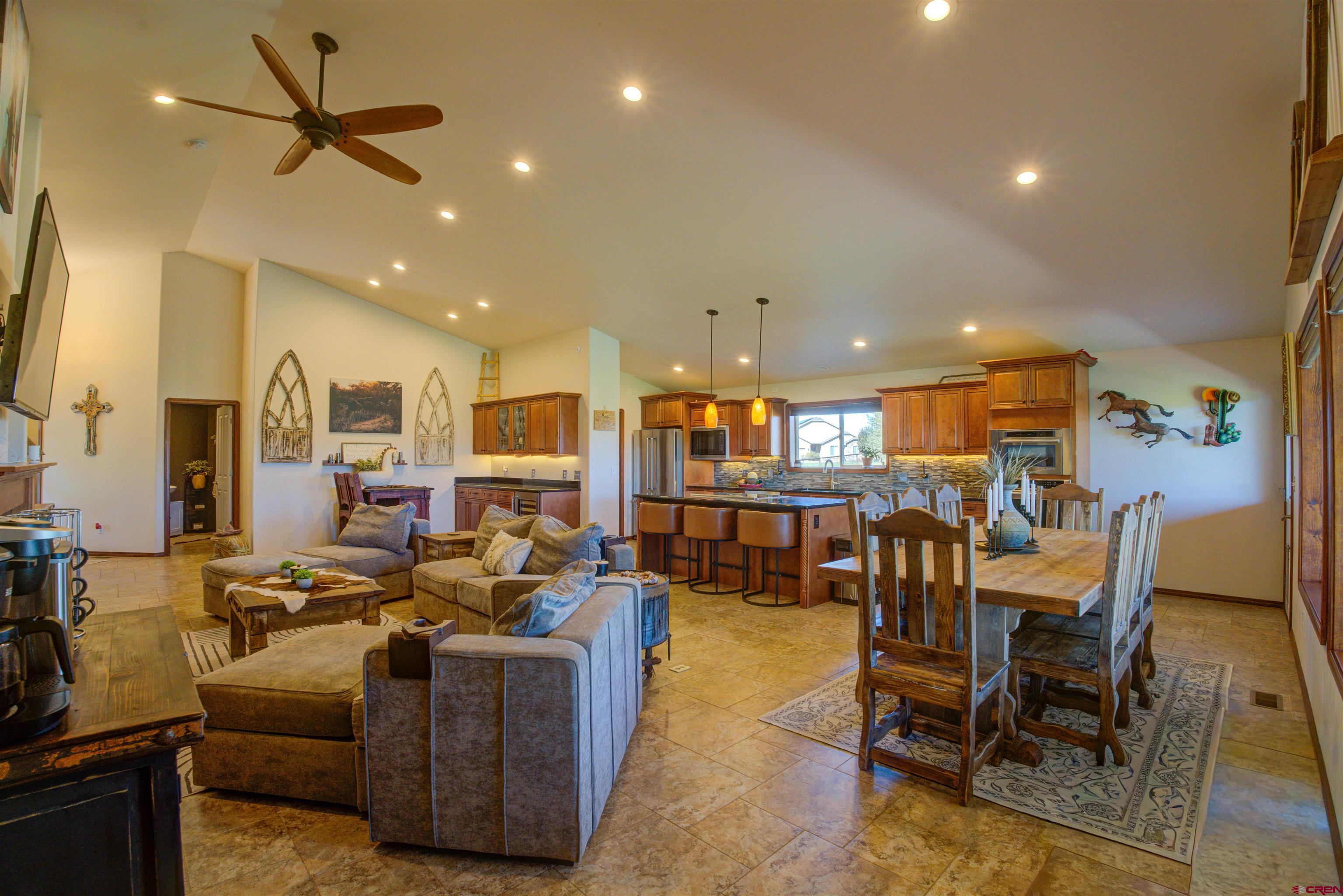 12336 Road 23.25 Loop Cortez, CO 81321 - Photo 16 of 43 a living room with furniture kitchen view and a large window