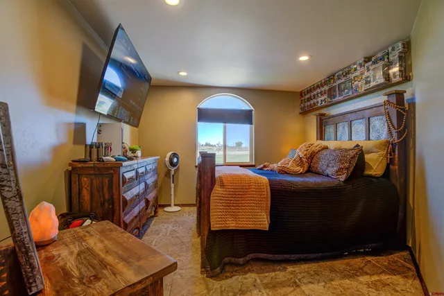 a living room with fireplace furniture and a large window