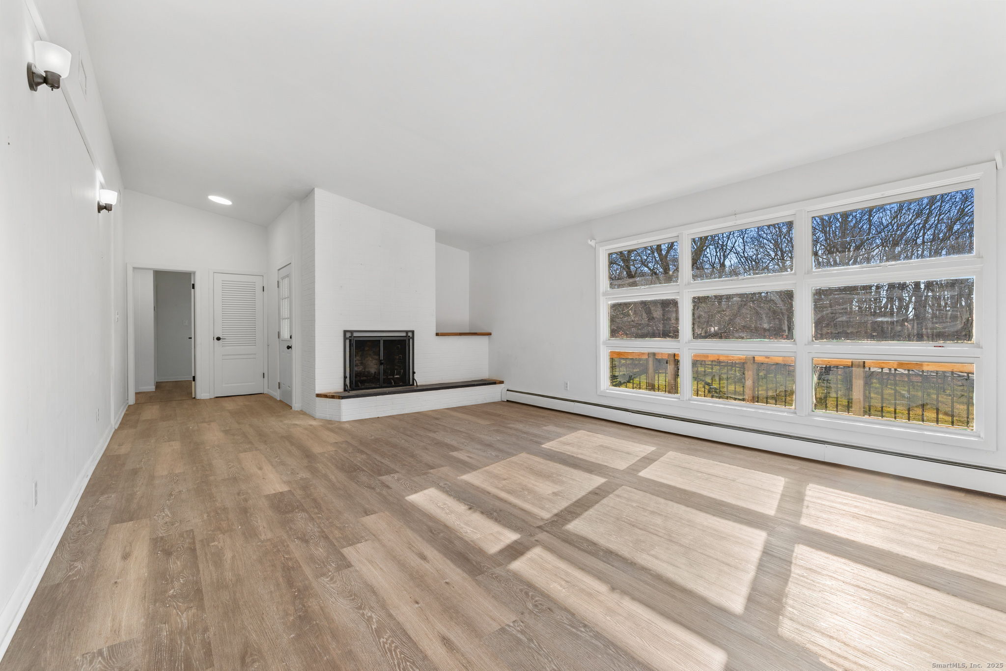 475 Parum Road Colchester, CT 06415 - Photo 11 of 28 a view of an empty room with a window and a kitchen