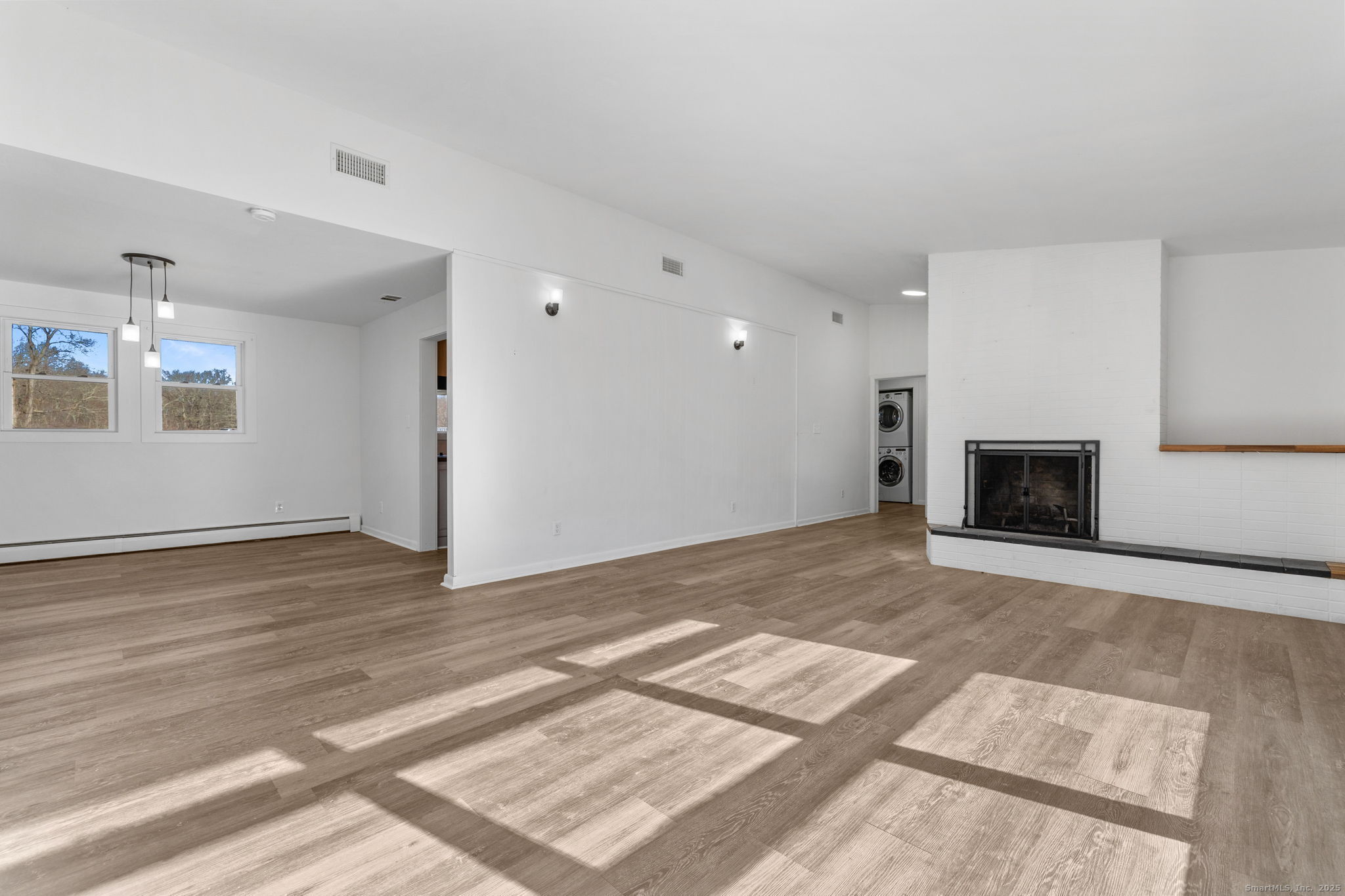 475 Parum Road Colchester, CT 06415 - Photo 12 of 28 a view of an empty room with wooden floor and a fireplace