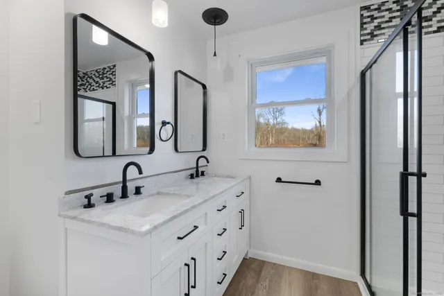 a bathroom with 2 sink and a mirror