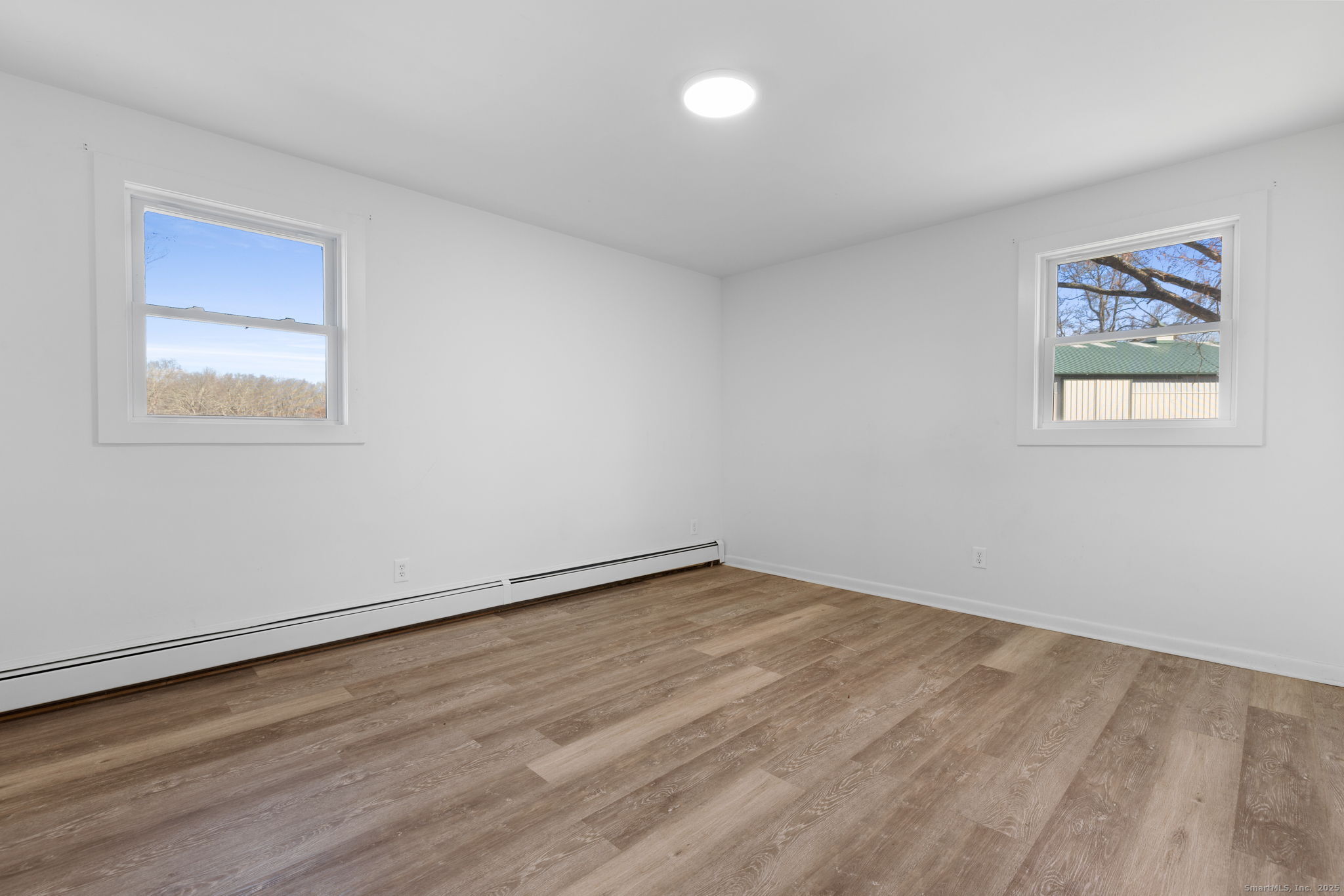 475 Parum Road Colchester, CT 06415 - Photo 17 of 28 a view of an empty room with wooden floor and a window