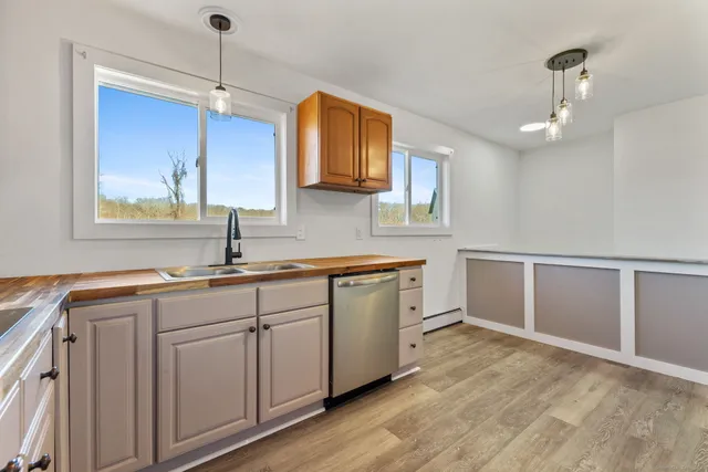 a kitchen with a sink cabinets and window