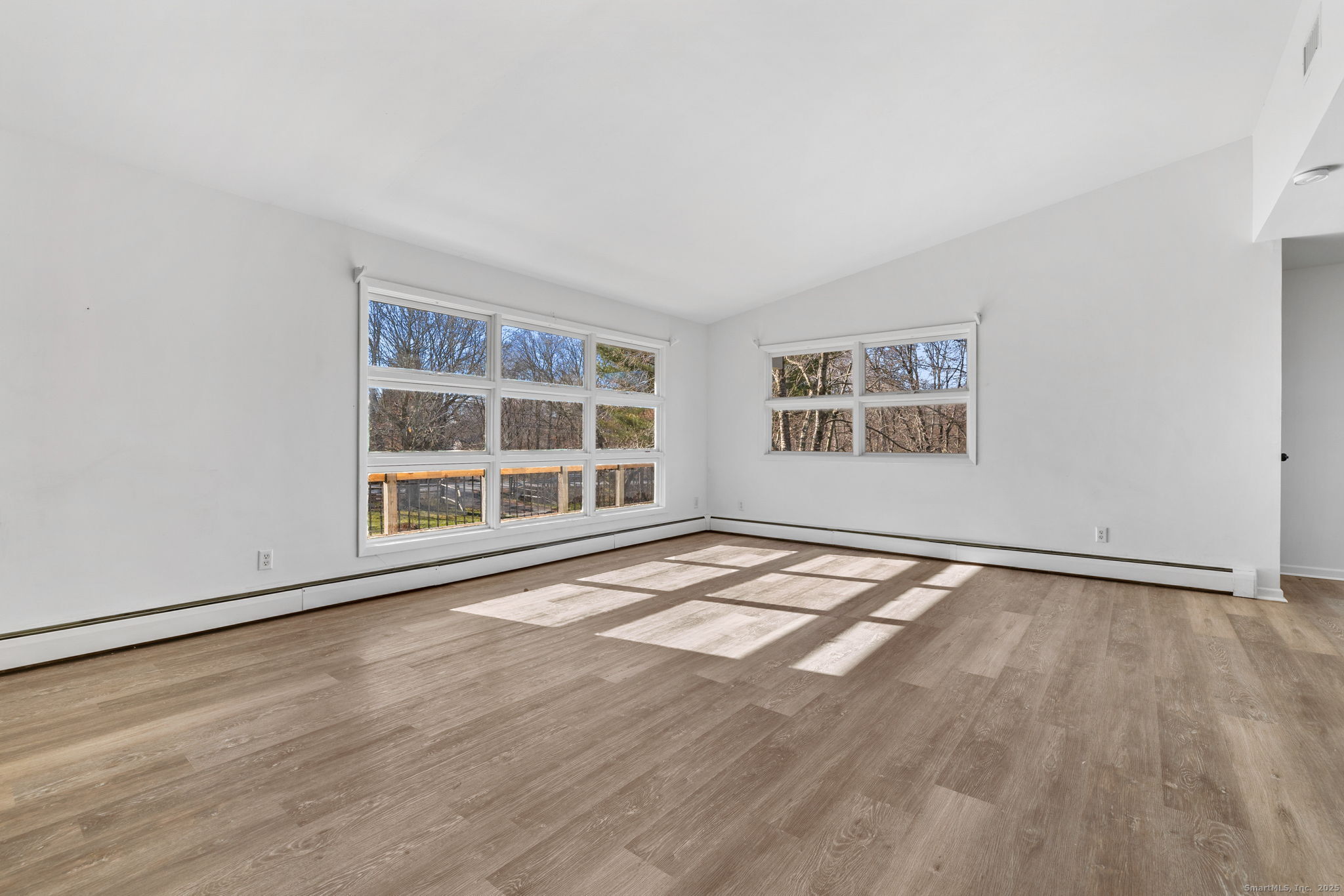 475 Parum Road Colchester, CT 06415 - Photo 10 of 28 an empty room with wooden floor and windows