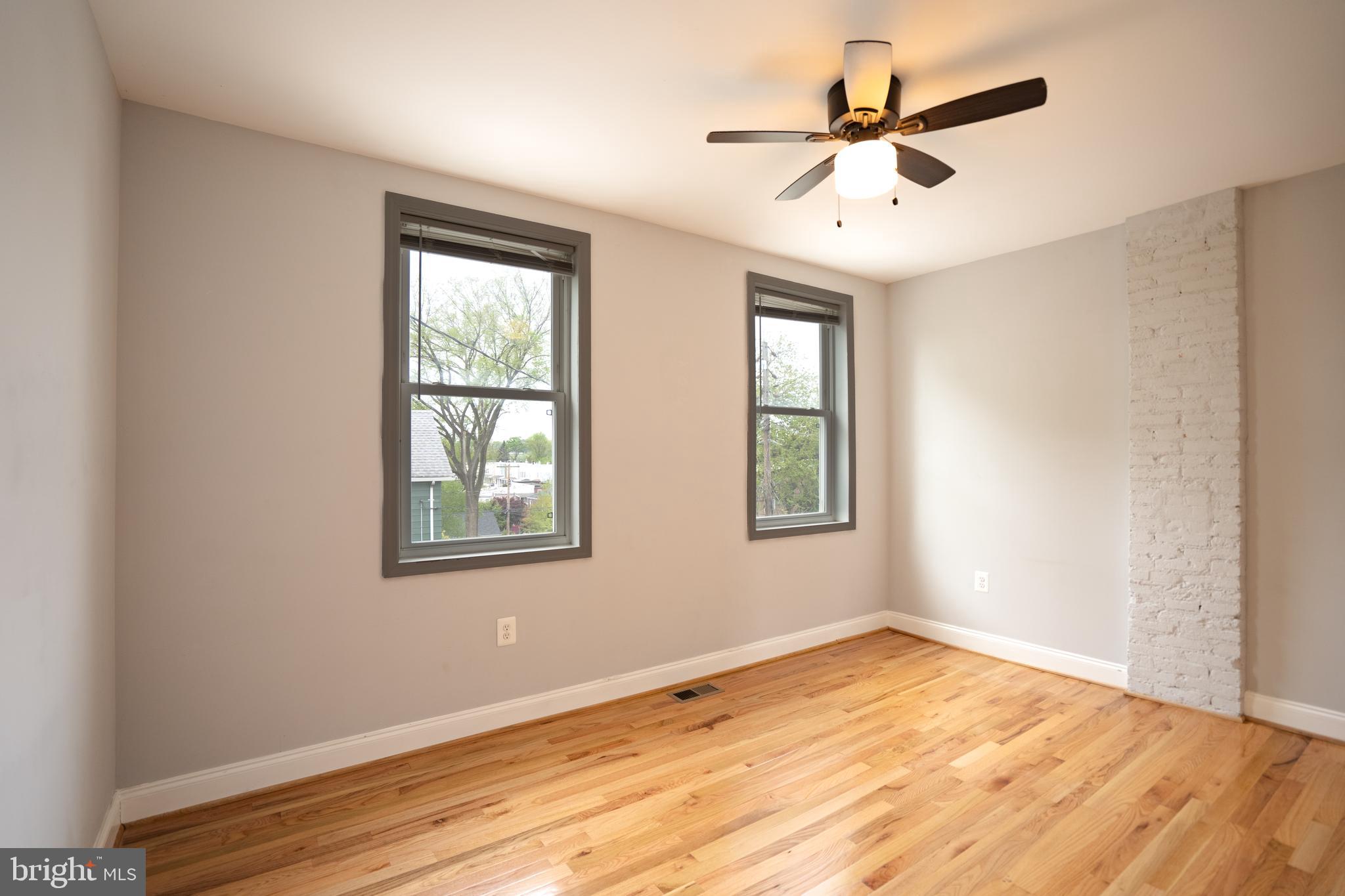 3804 Falls Road Baltimore, MD 21211 - Photo 8 of 18 a view of empty room with wooden floor and fan