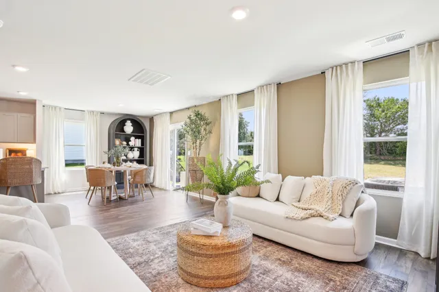 a view of a a dining room with furniture window and wooden floor