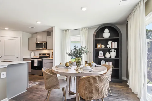 a large kitchen with a table and chairs