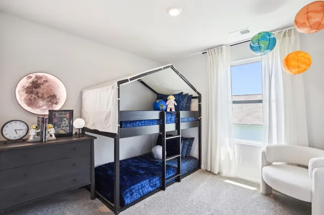 a bedroom with furniture and a window