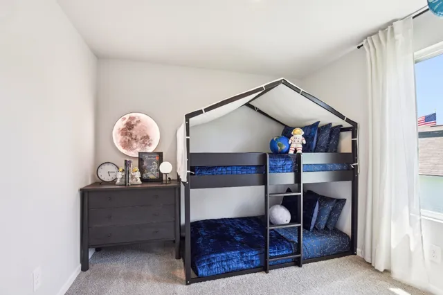 a bedroom with furniture and a window