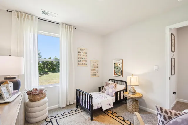 a bedroom with bed and a window