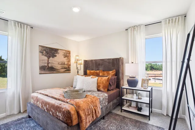 a bedroom with a large bed and a dresser