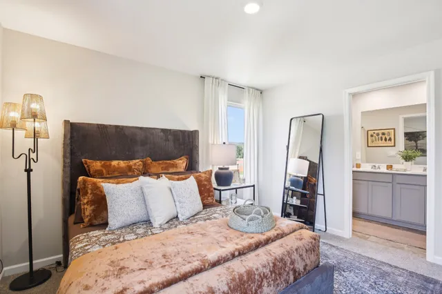 a bathroom with a granite countertop sink vanity mirror and toilet