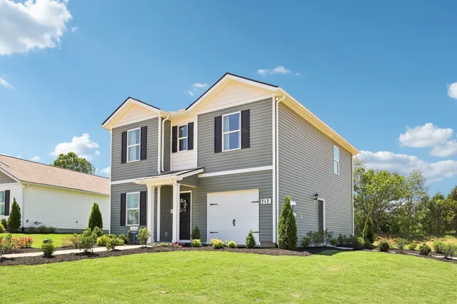 a front view of house with yard and green space